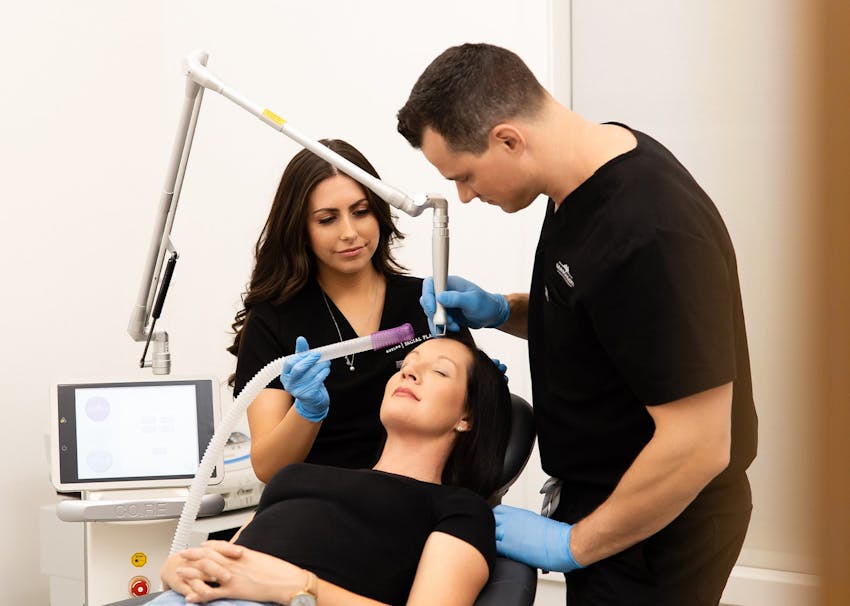 Dr. Brace & Jocelyn helping patient