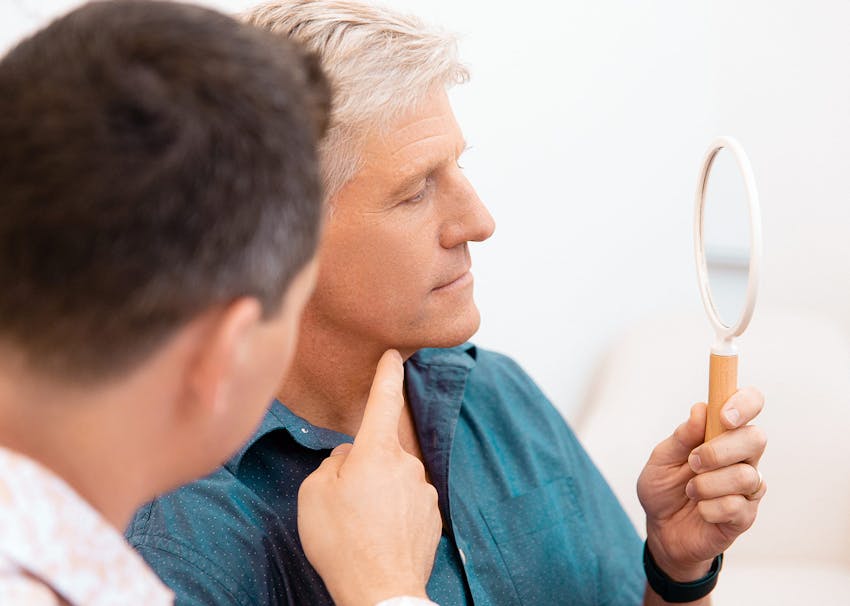 Dr. Brace Examining patient's chin