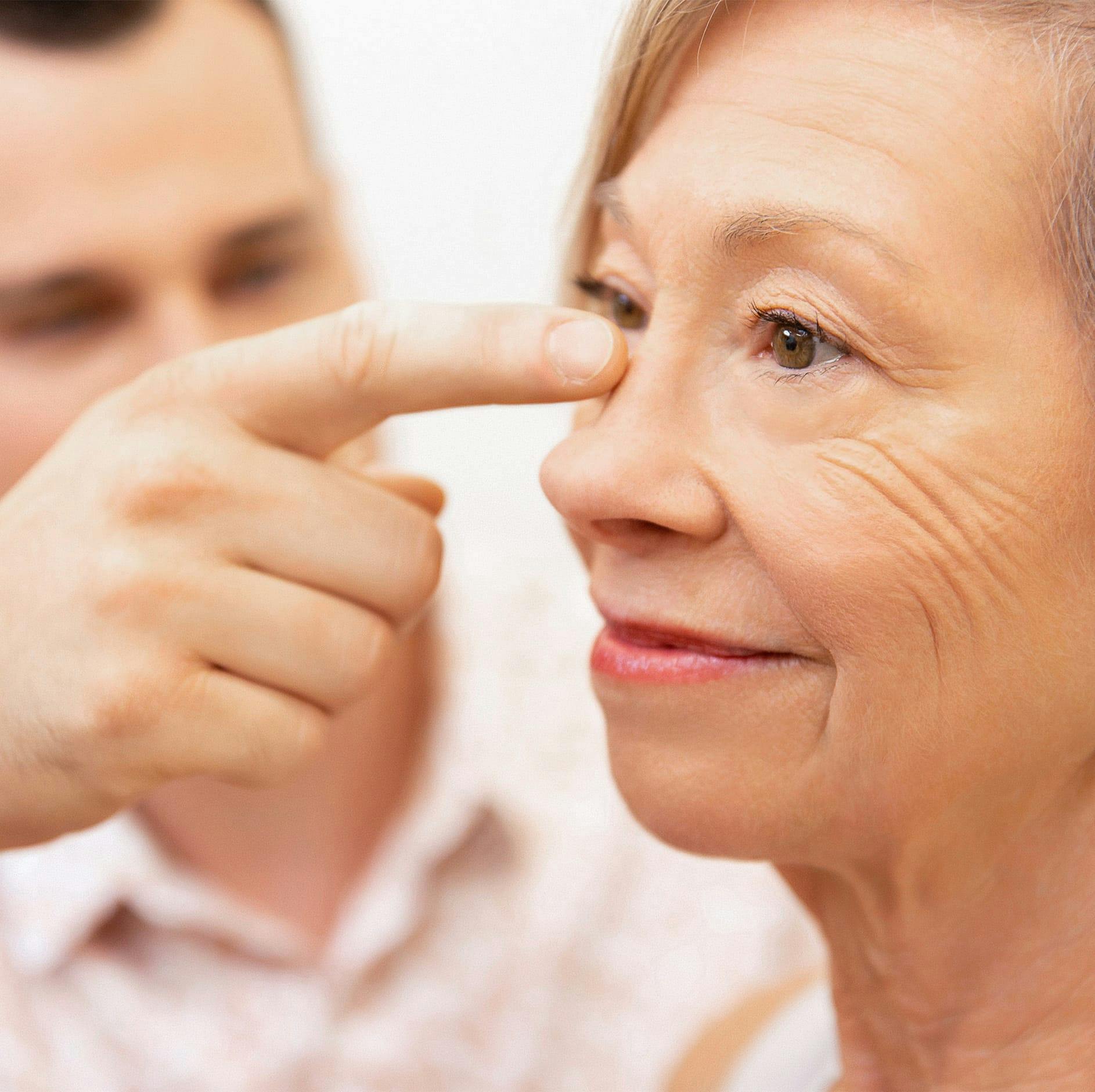 Dr. Brace examining patient's nose
