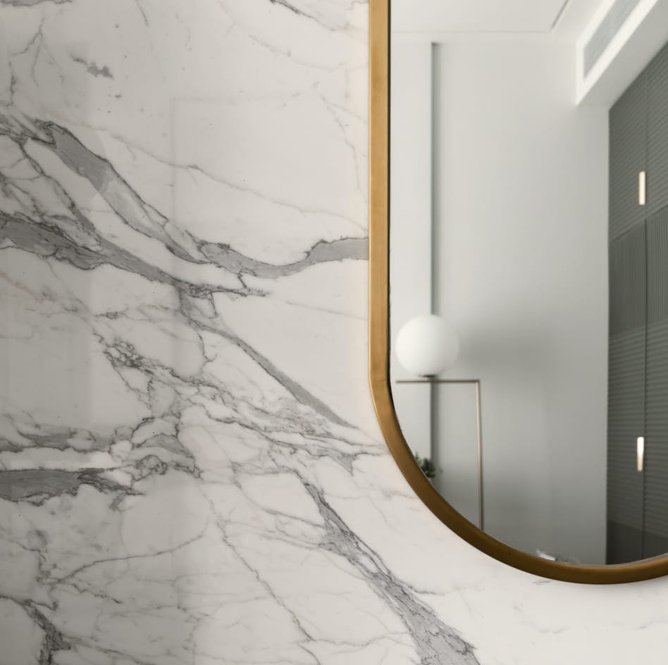 Image of a mirror against a marble wall