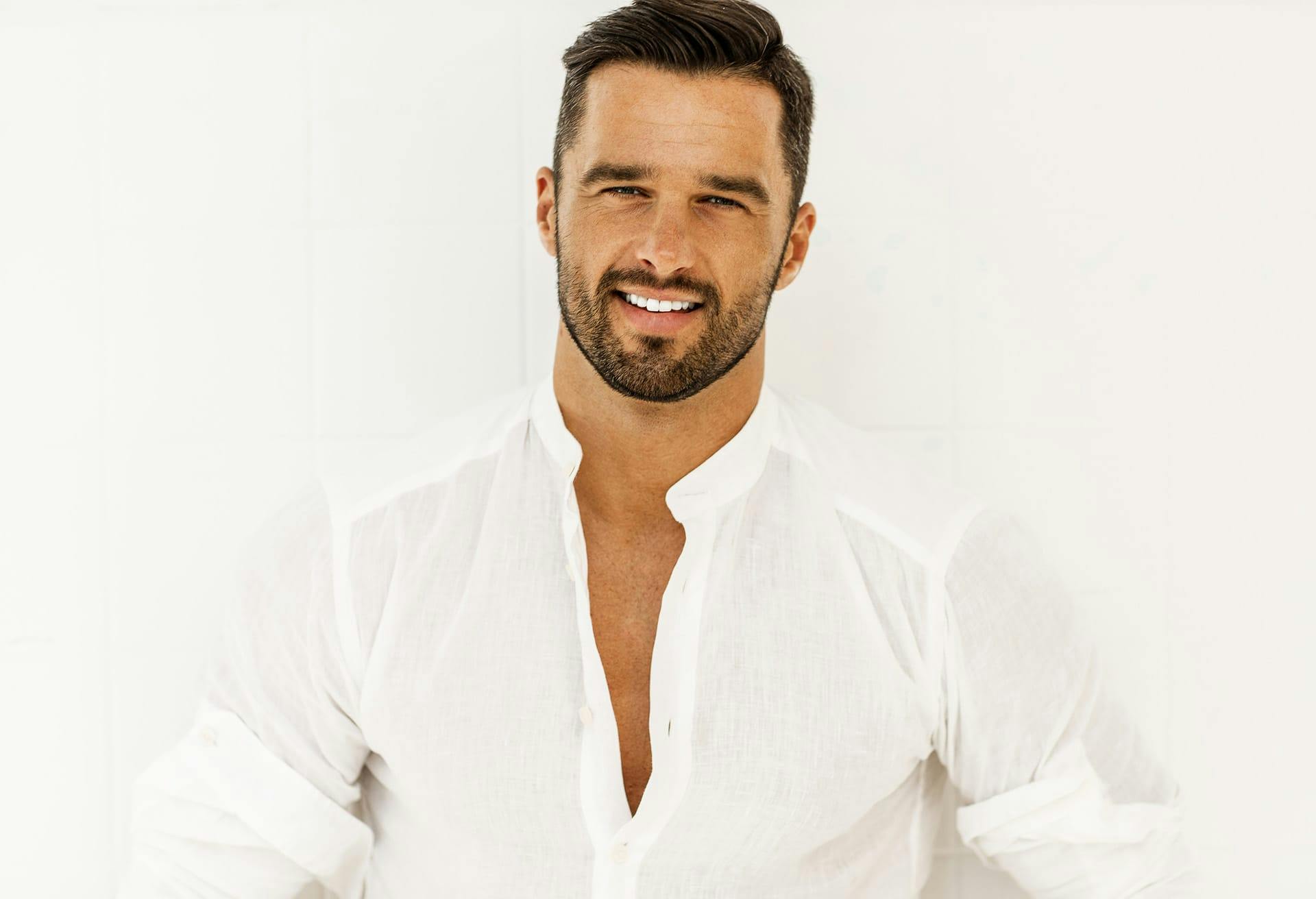 Man smiling wearing button up shirt