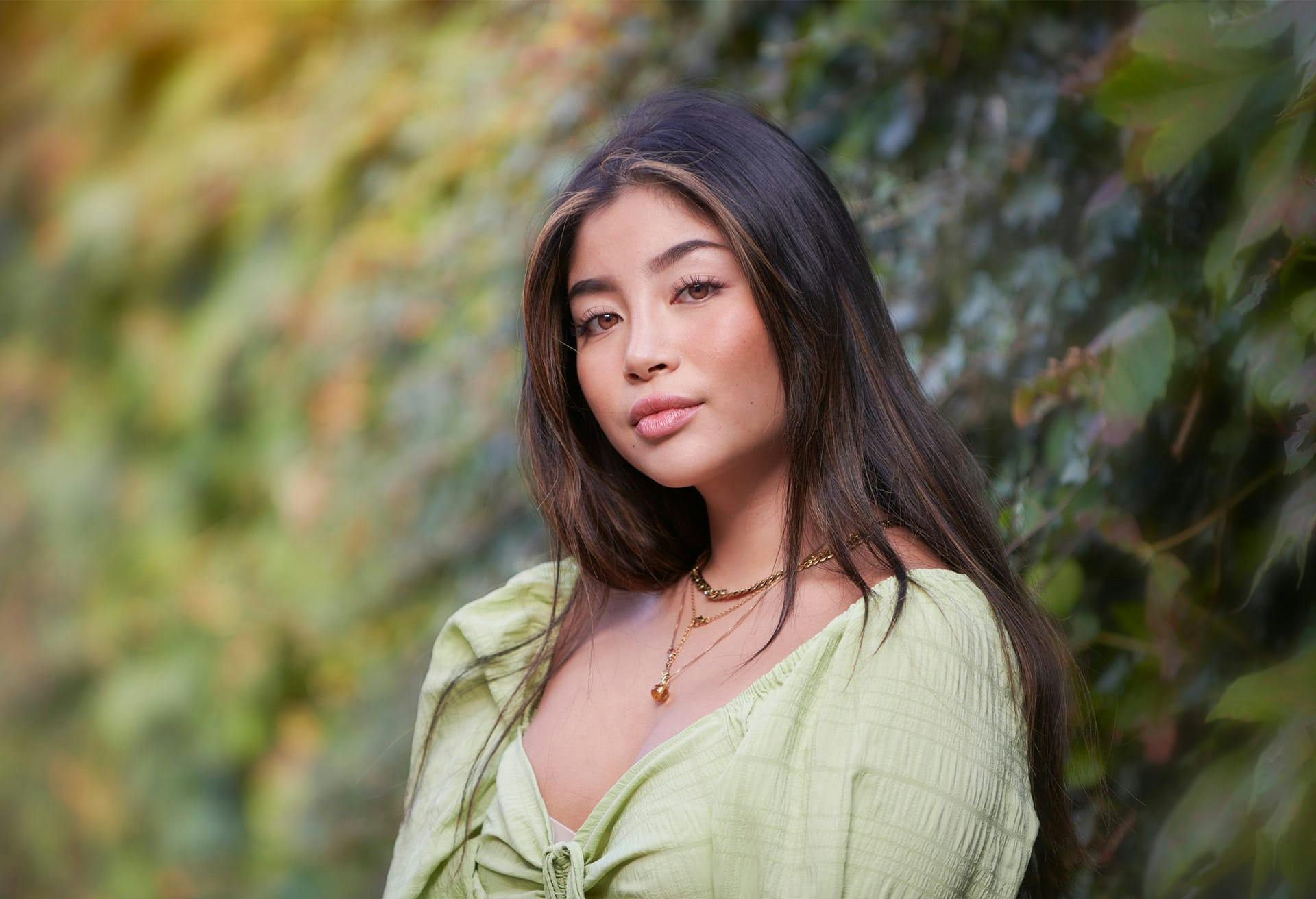 woman standing next to plants outside