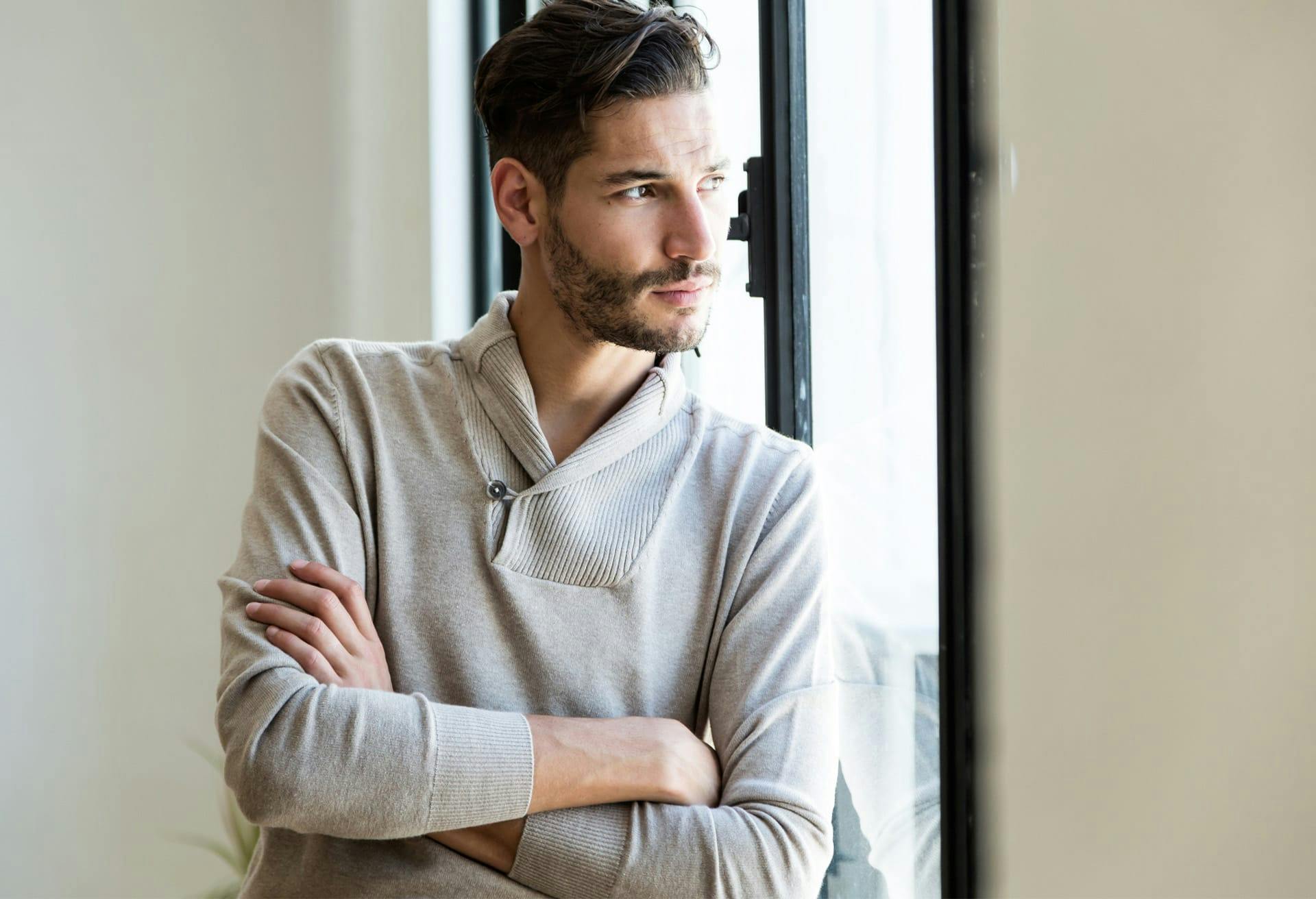 man leaning against window