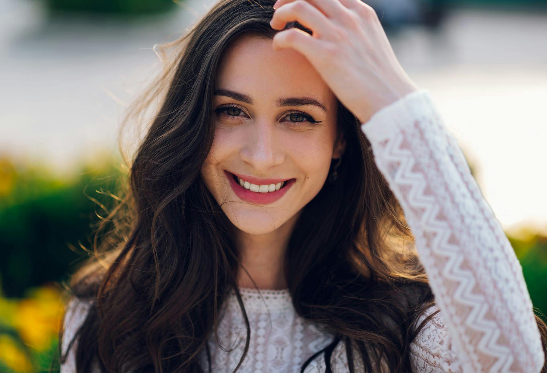 Woman smiling with hand in her hair