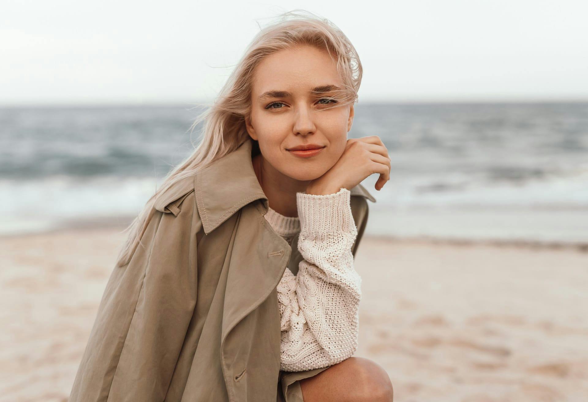 woman wearing coat at the beach