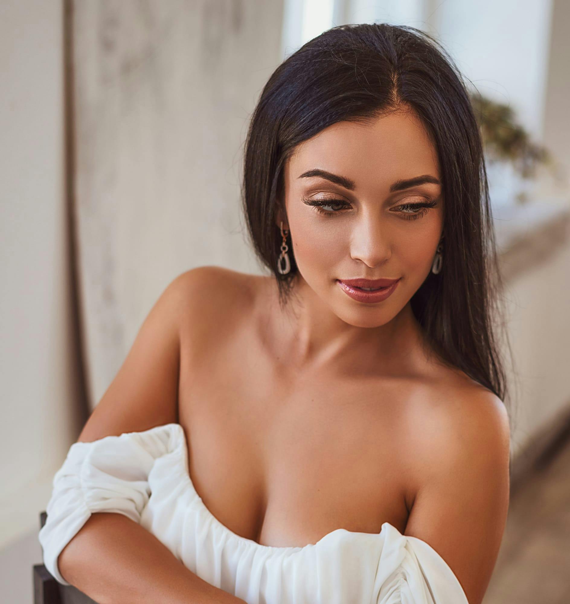 Woman in a low-cut dress looking to the side