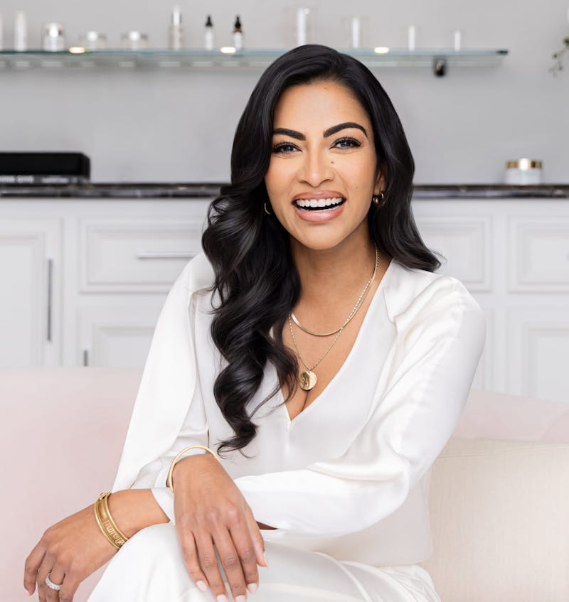 Dr. Sunder sitting with her arms crossed