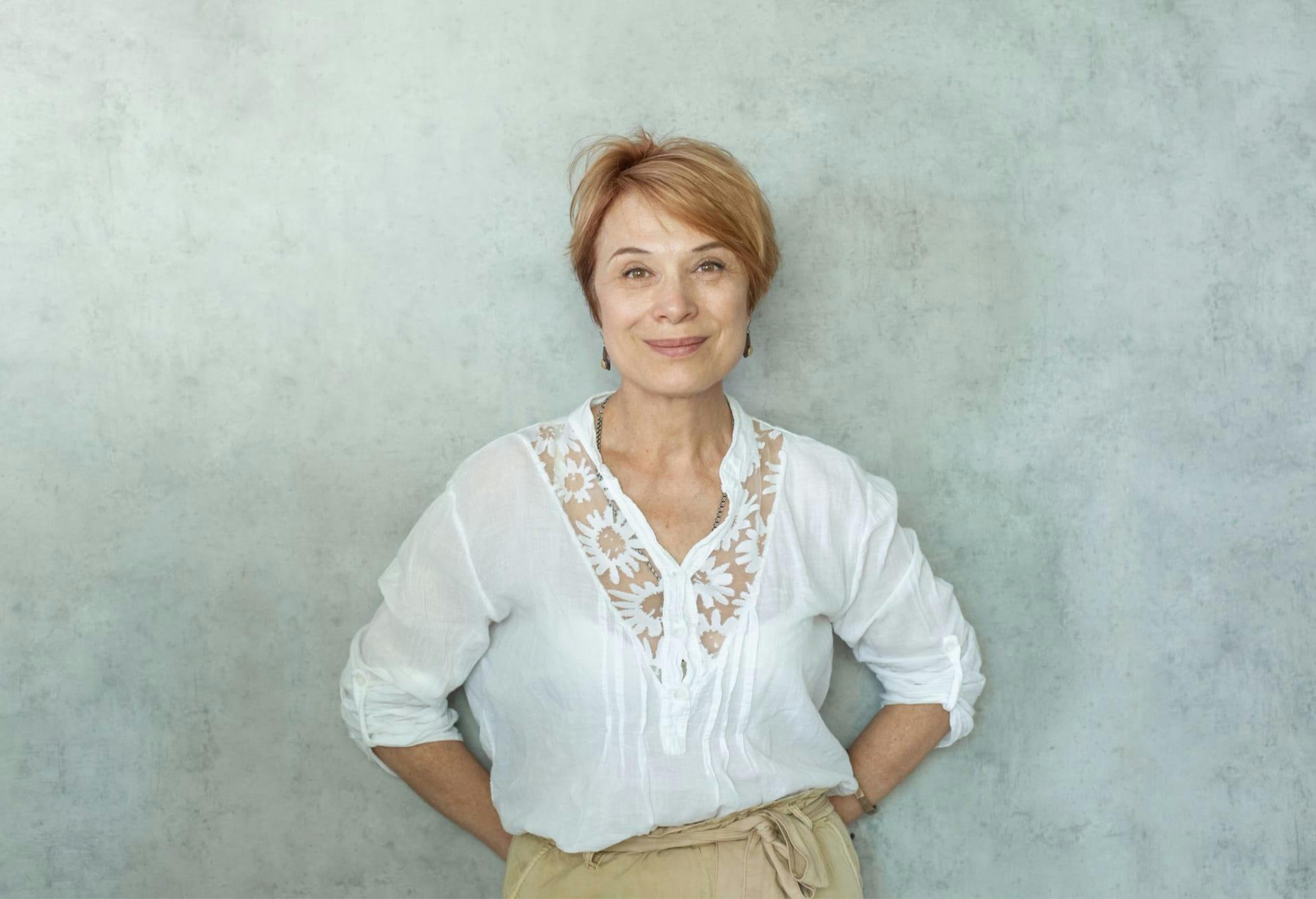 smiling older woman with hand on her hips