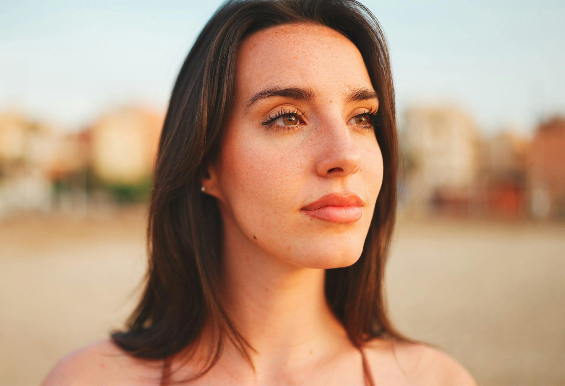 Beautiful woman at the beach with long brown hair