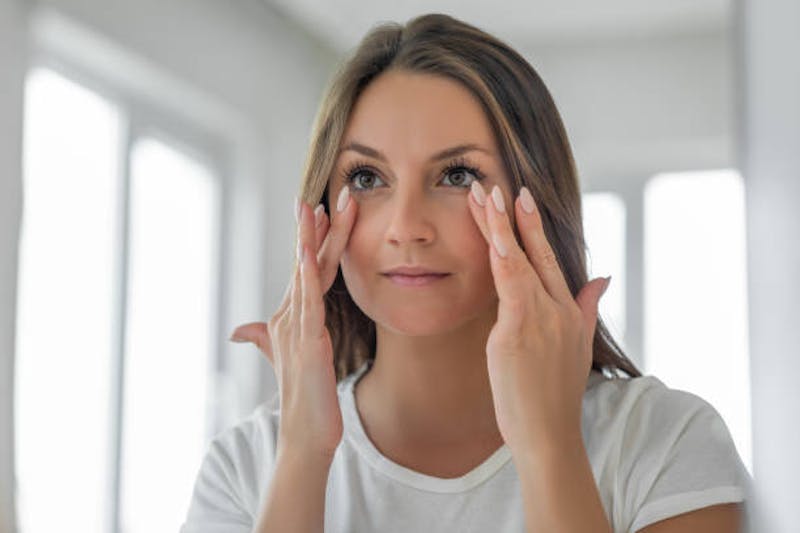Woman Looking at Her Eyes