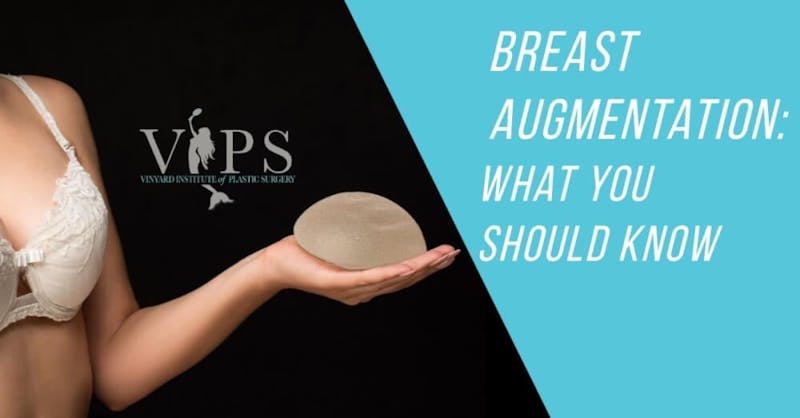 Woman holding a breast implant
