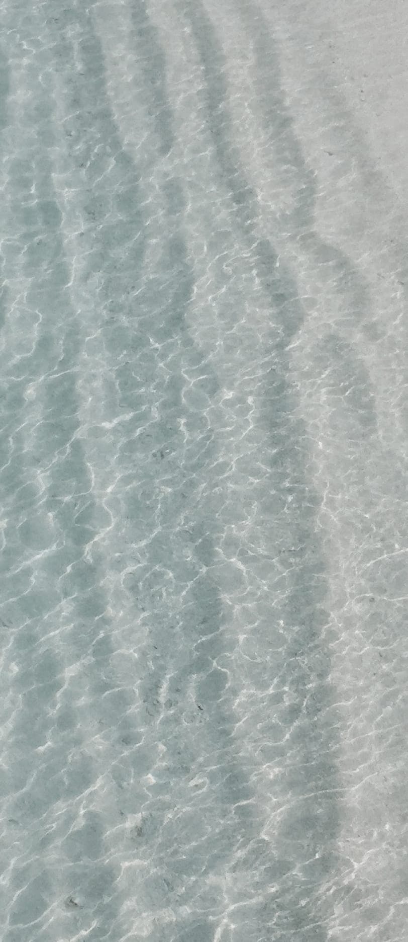waves in the sand in shallow water