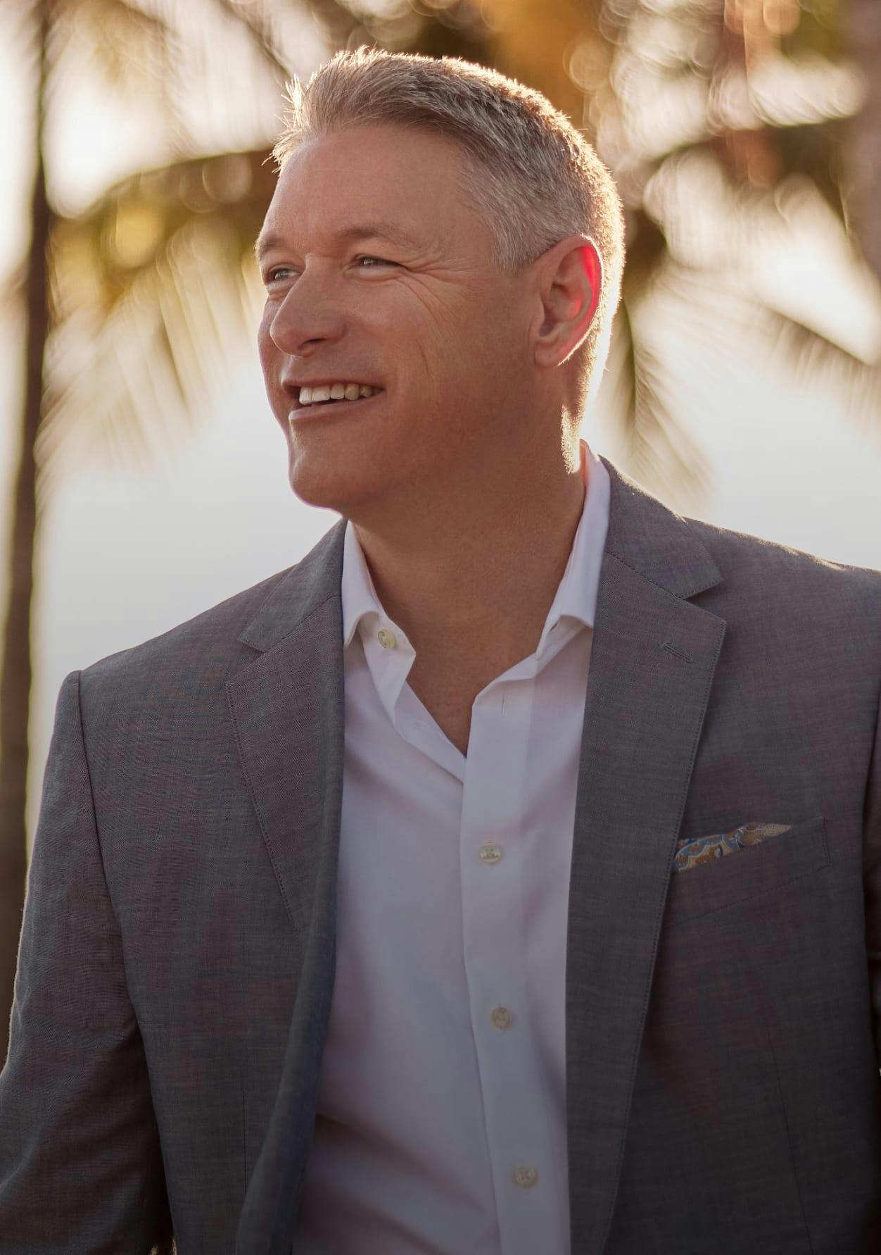 Man looking off camera and smiling.