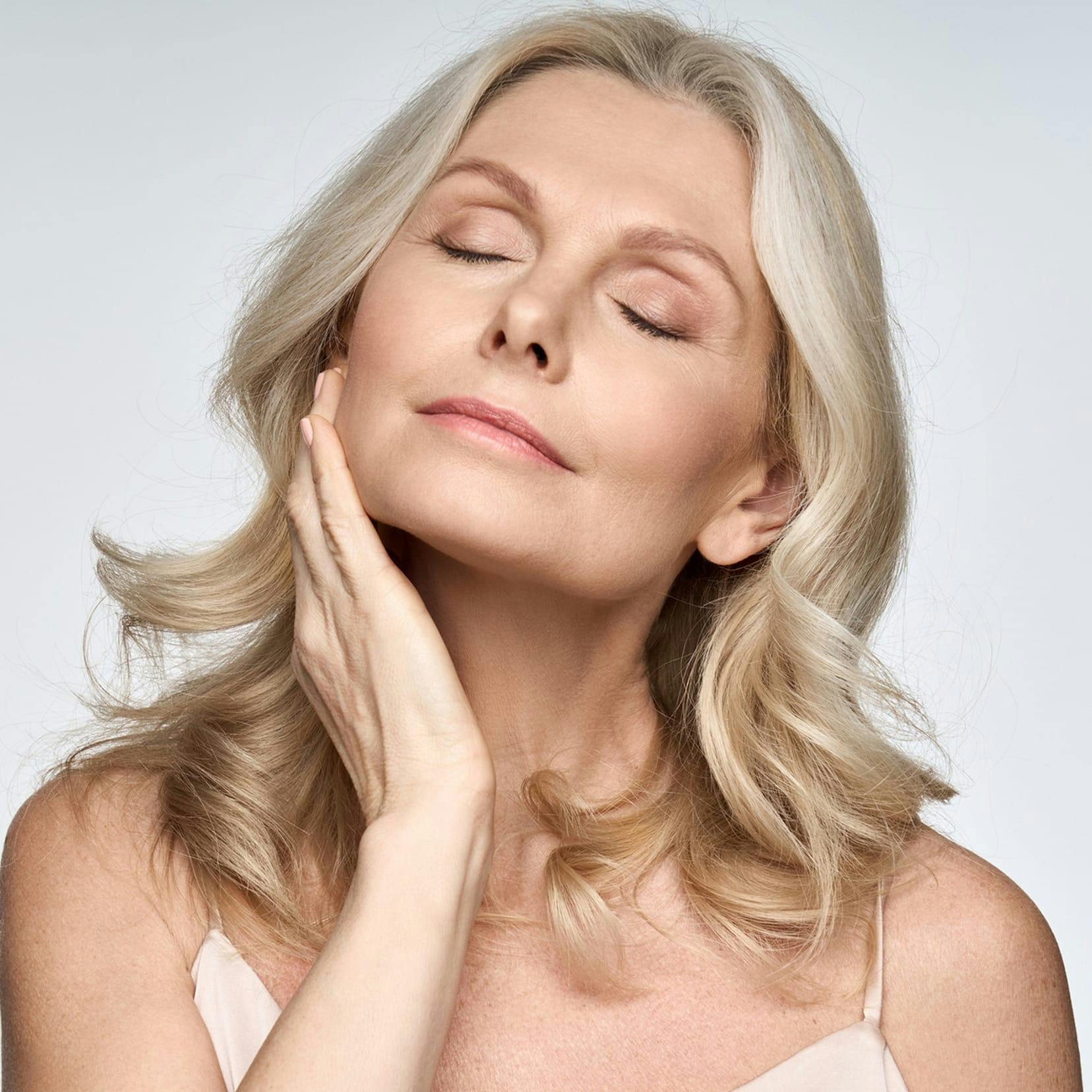 older woman touching her chin