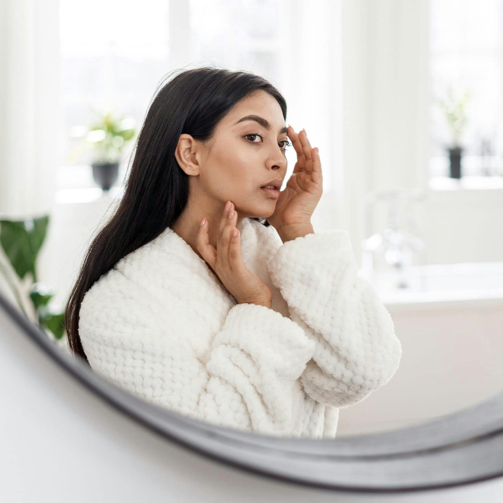woman looking in mirror