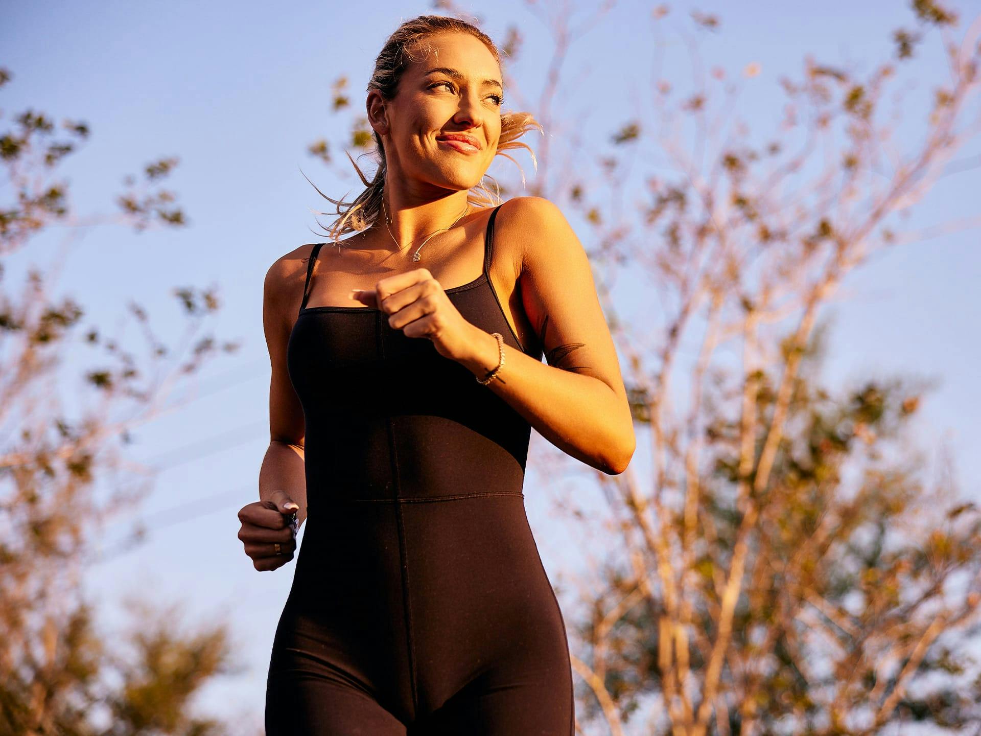 Woman in black bodysuit running