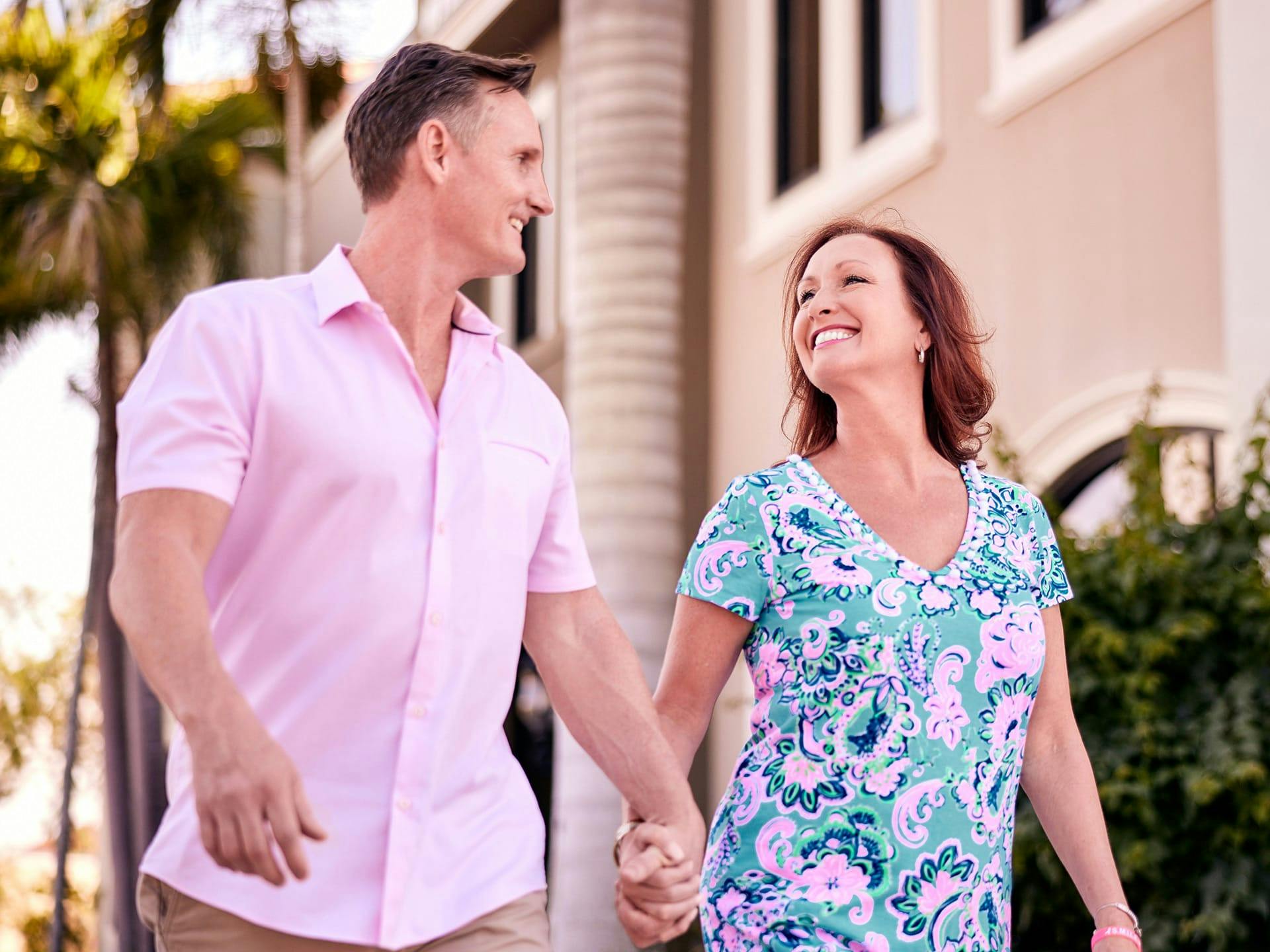 Woman and man walking together holding hands