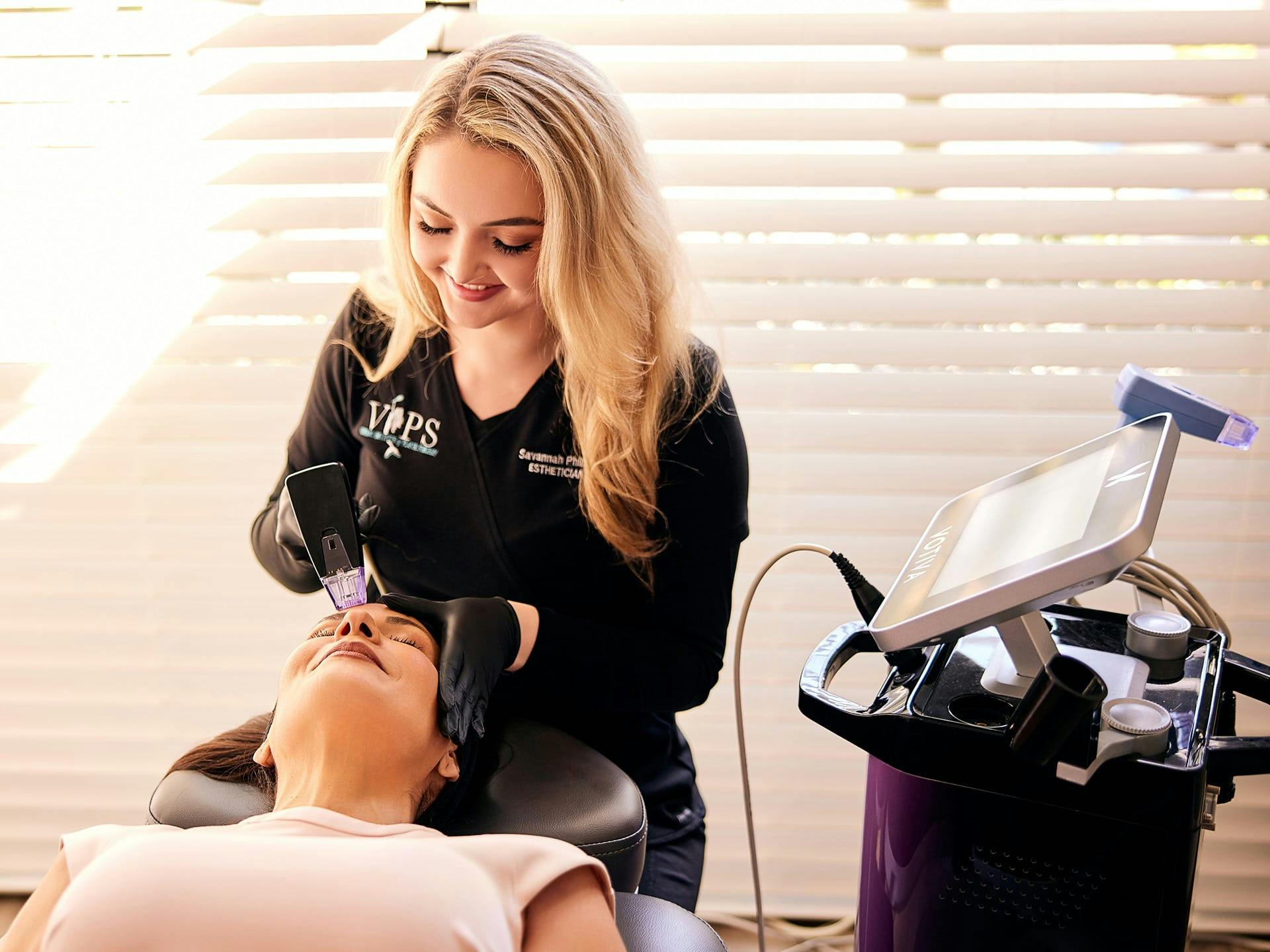Savannah Phillips, aesthetician/laser tech with patient