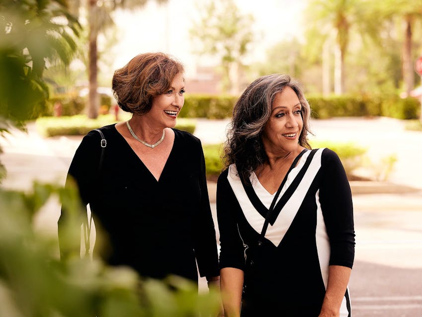 Two woman standing together outside