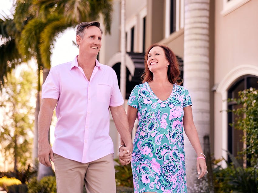 Man and woman walking together holding hands