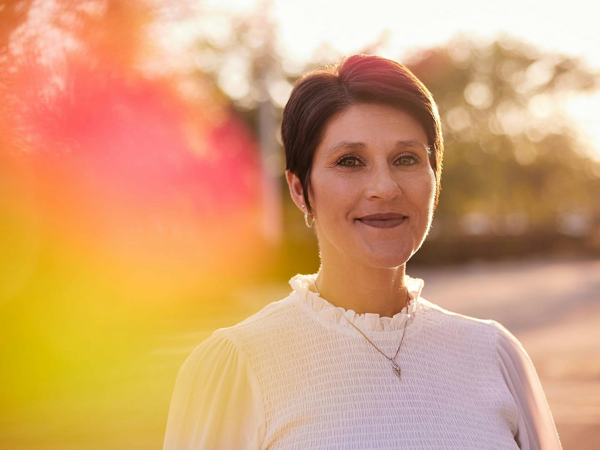 Woman standing outside smiling