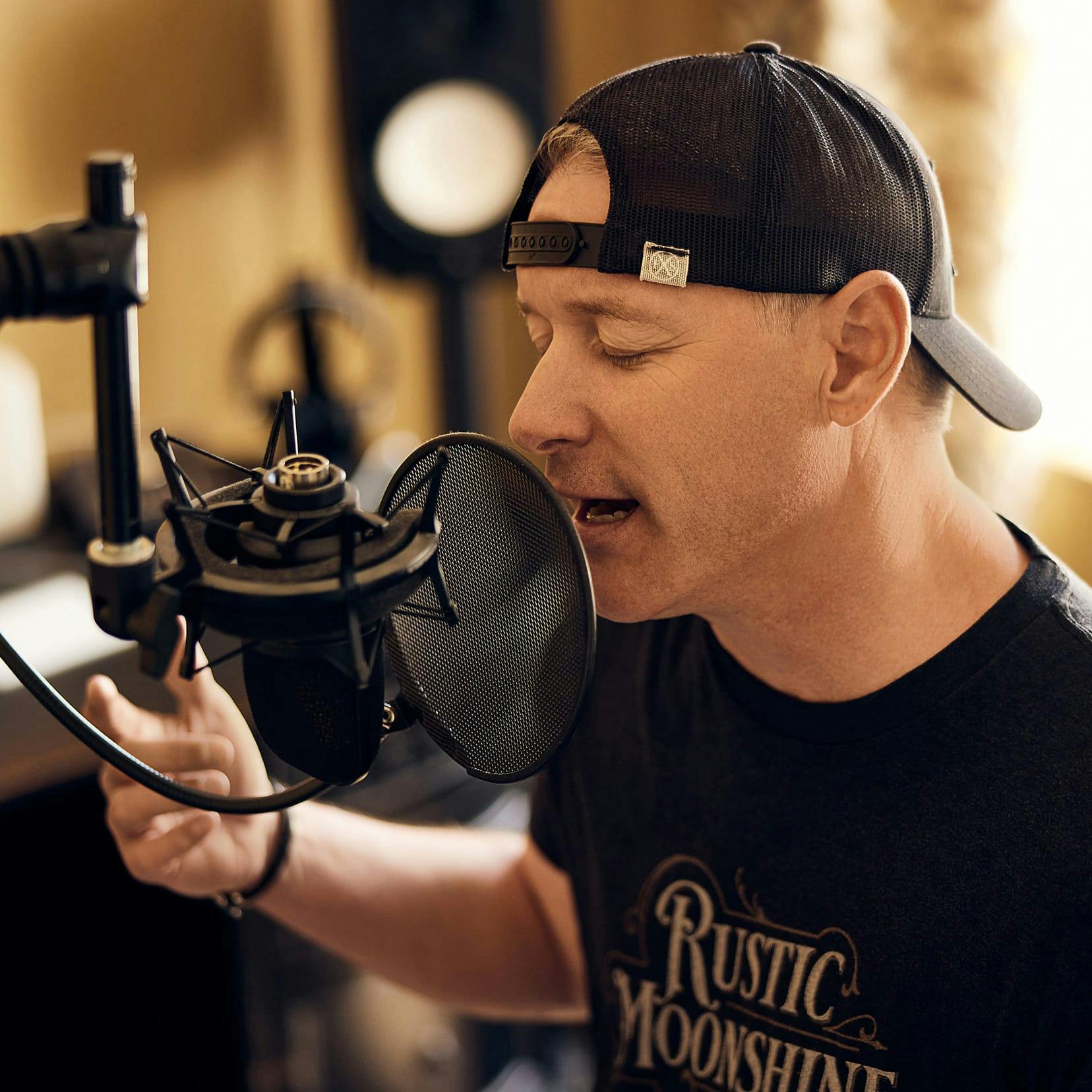 Dr. Vinyard singing into a microphone