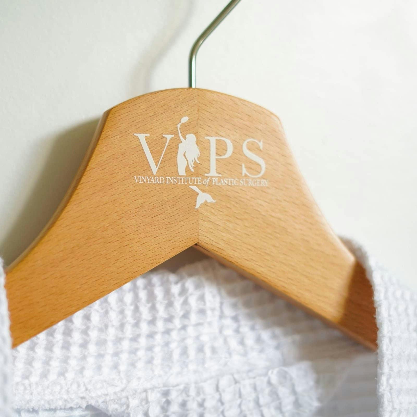 white robe hanging on a wooden hanger