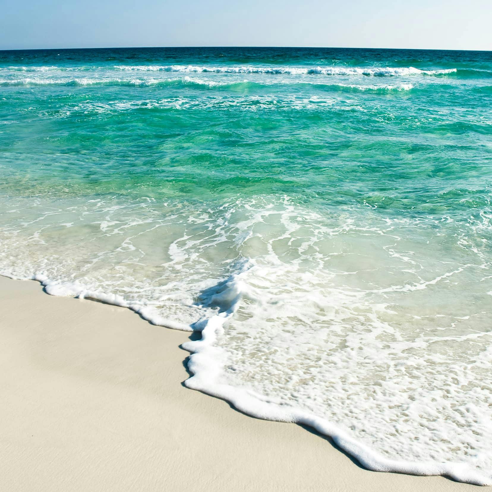 sandy beach with teal water