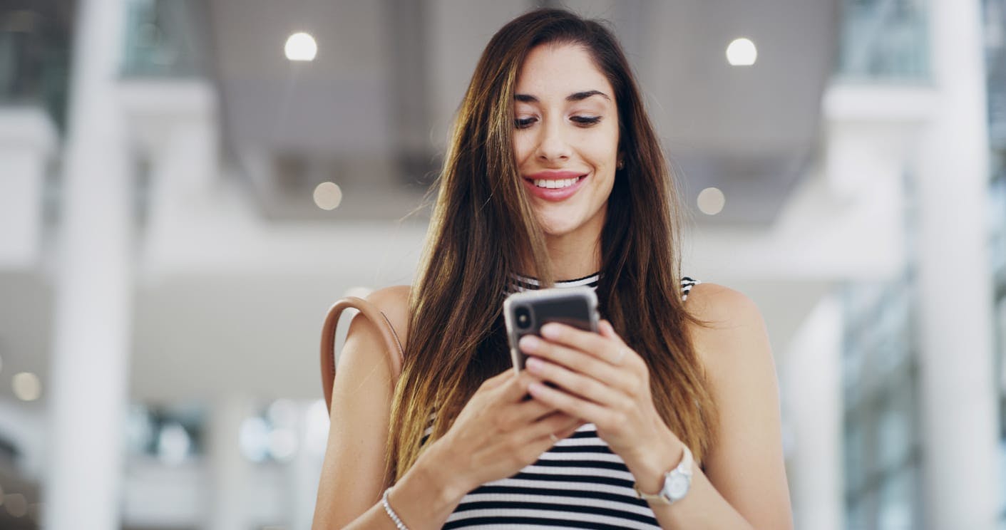 woman smiling at smartphone