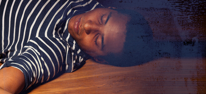 A young man appearing to be asleep.