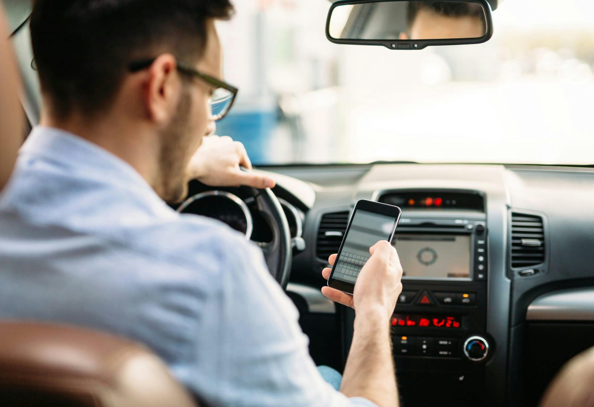 man on phone while driving