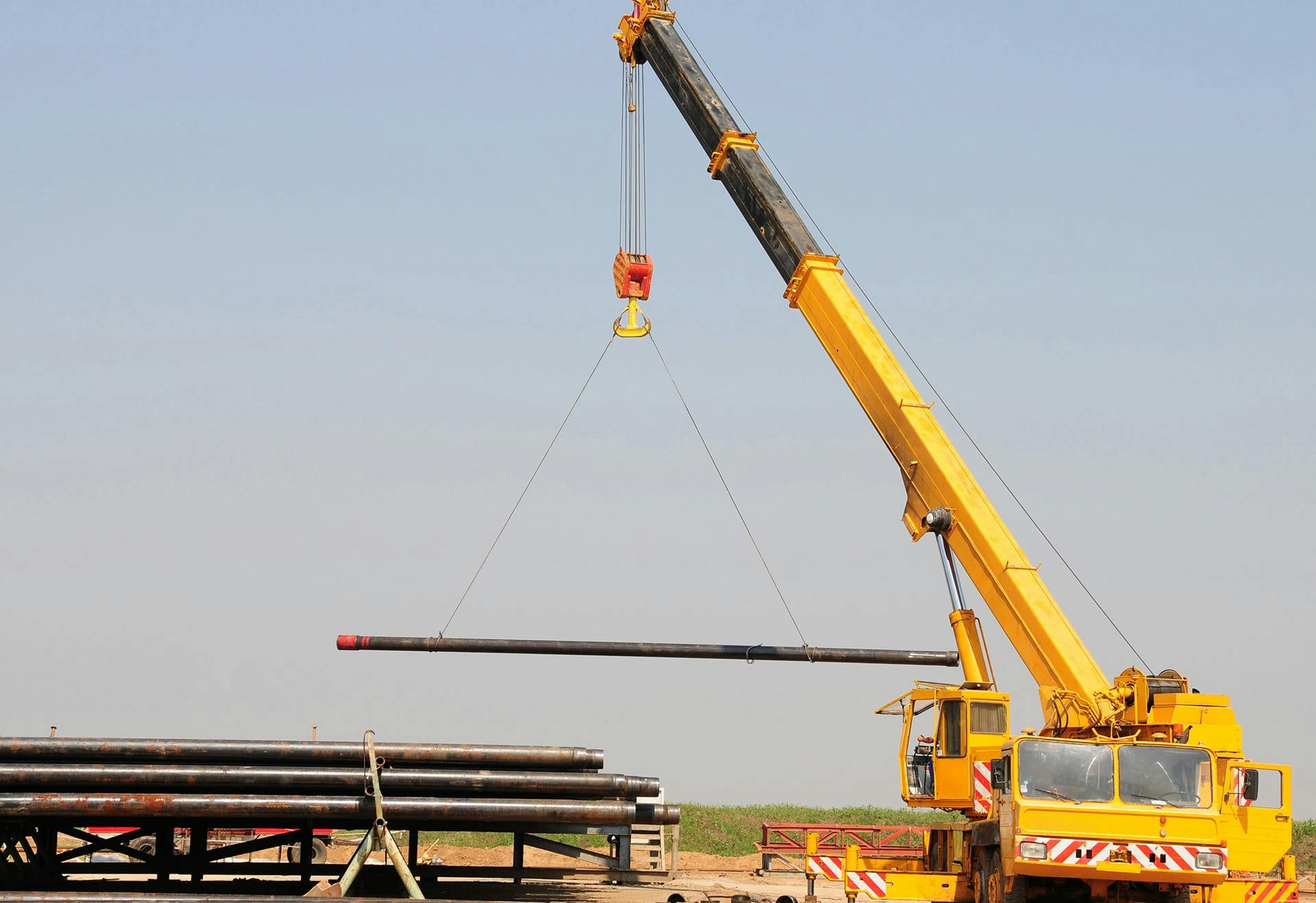 crane machine moving pipes