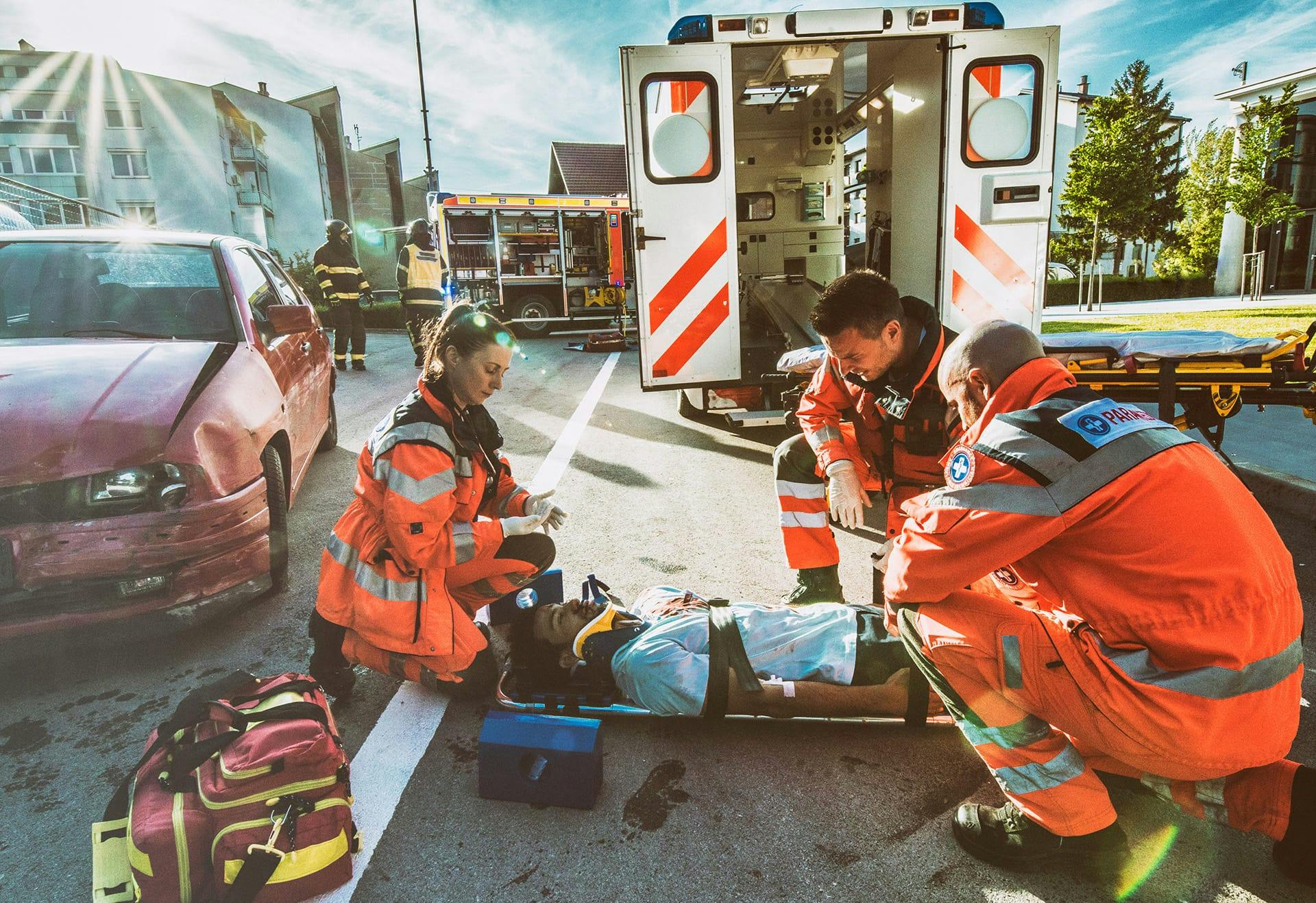 paramedics helping person on stretcher