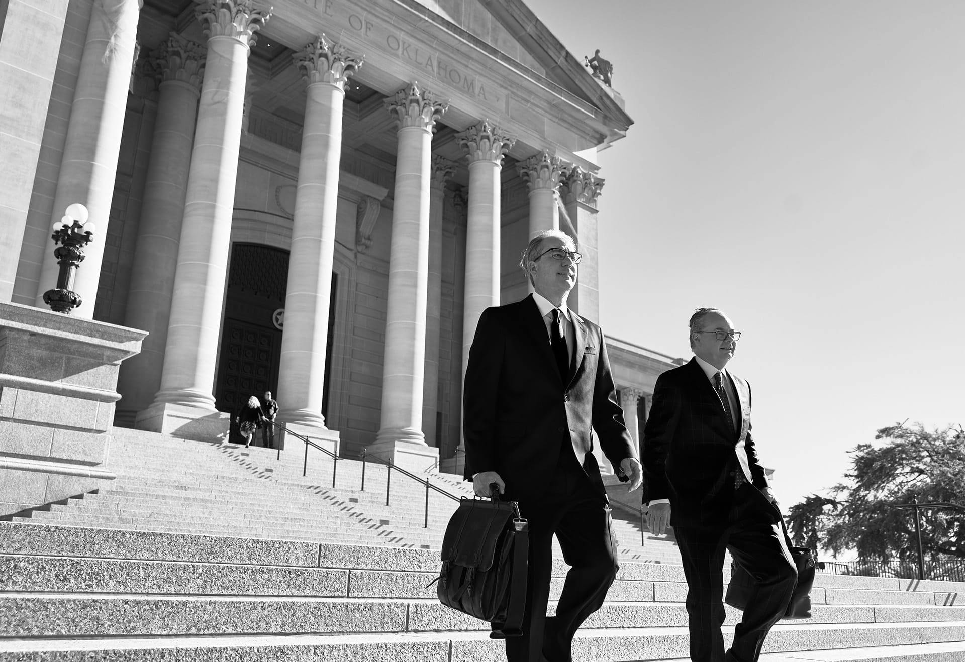 black and white photo of Stipe and Belote walking outside