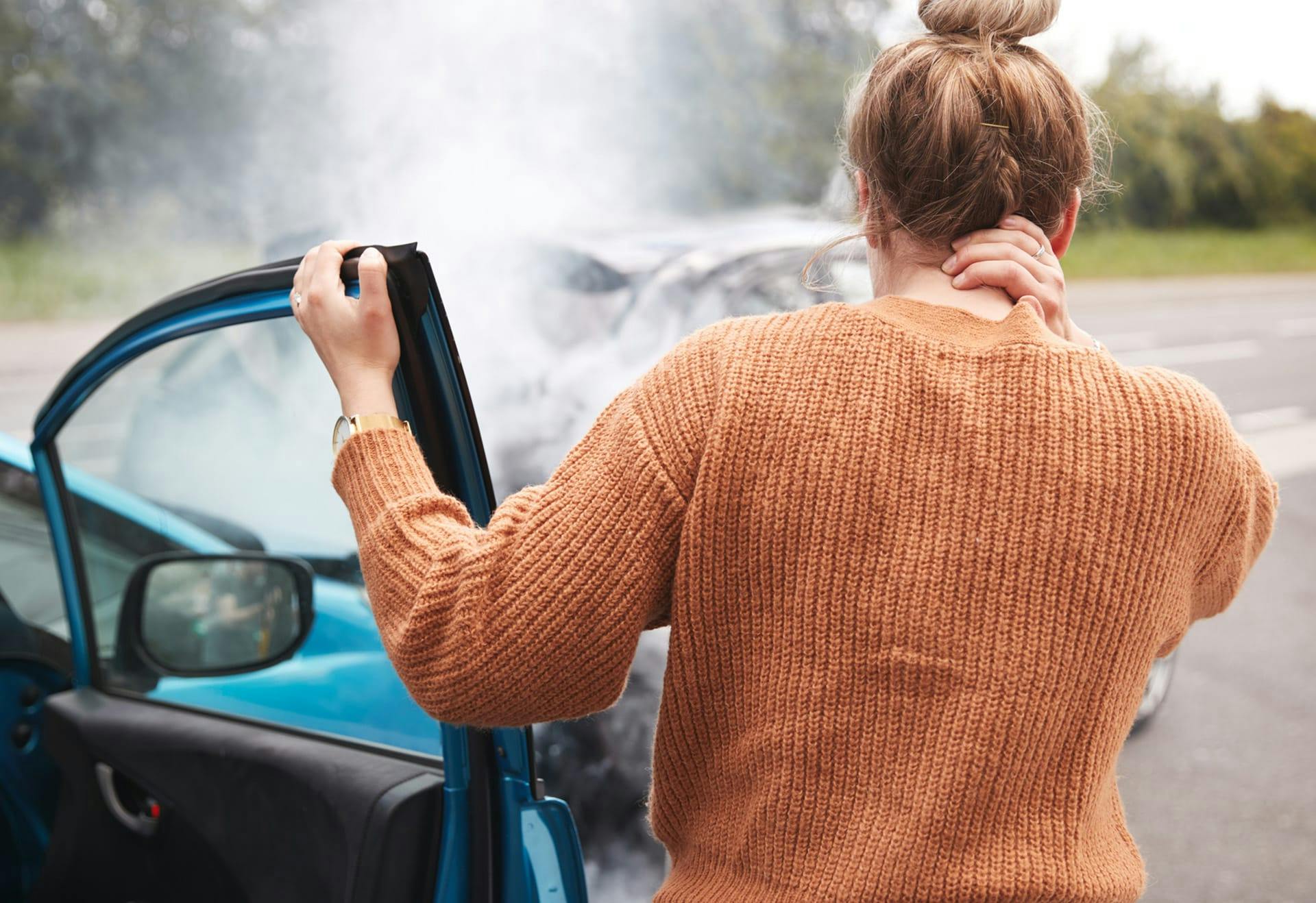 woman holding neck after crash