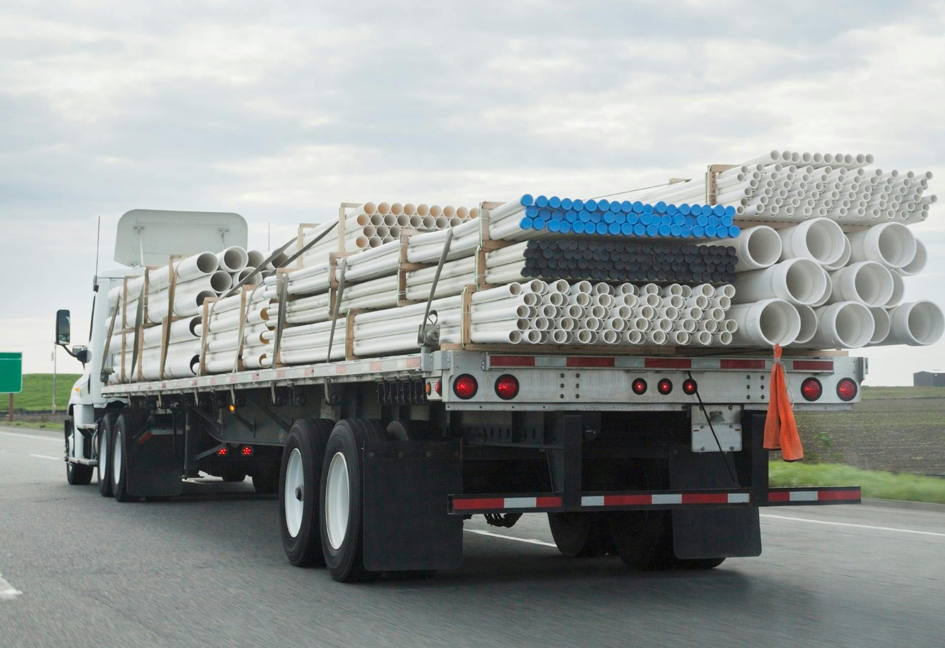 freight truck carrying piping