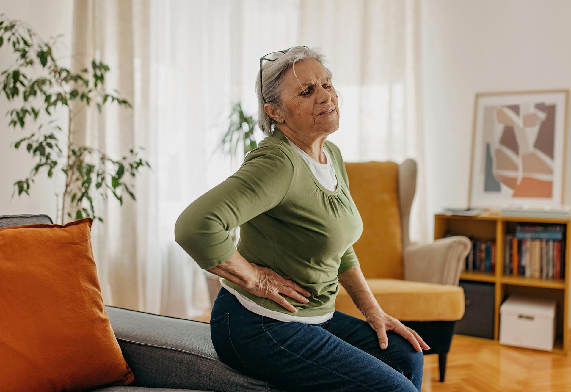 elderly woman holding her hip in pain