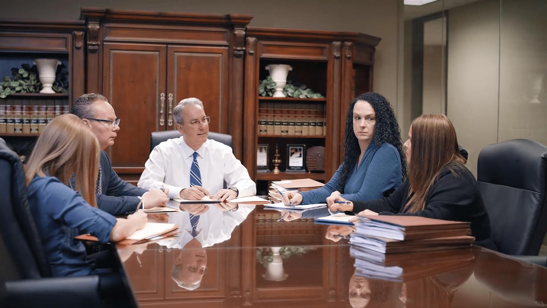 Stipe and Belote, attorneys at law, meeting with clients in the office.