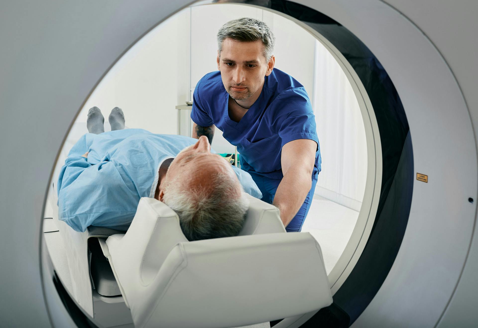 Man being pushed into an MRI machine.