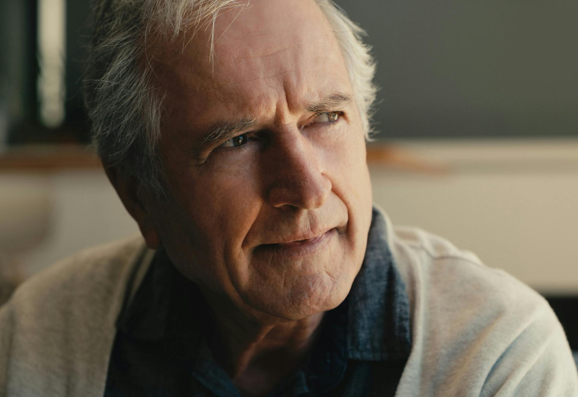 Elderly man looking into the distance.