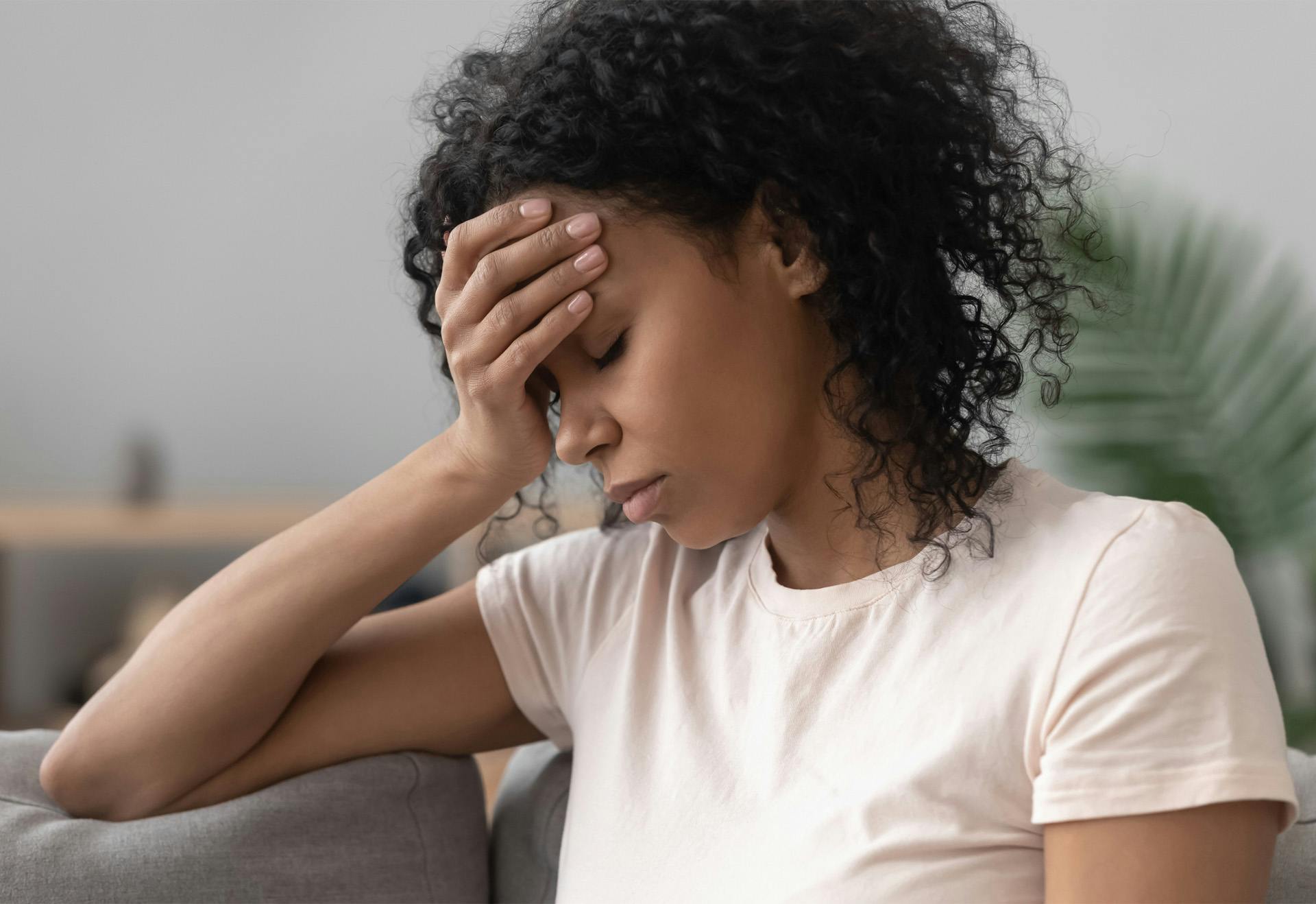 Sad woman leaning on her hand.