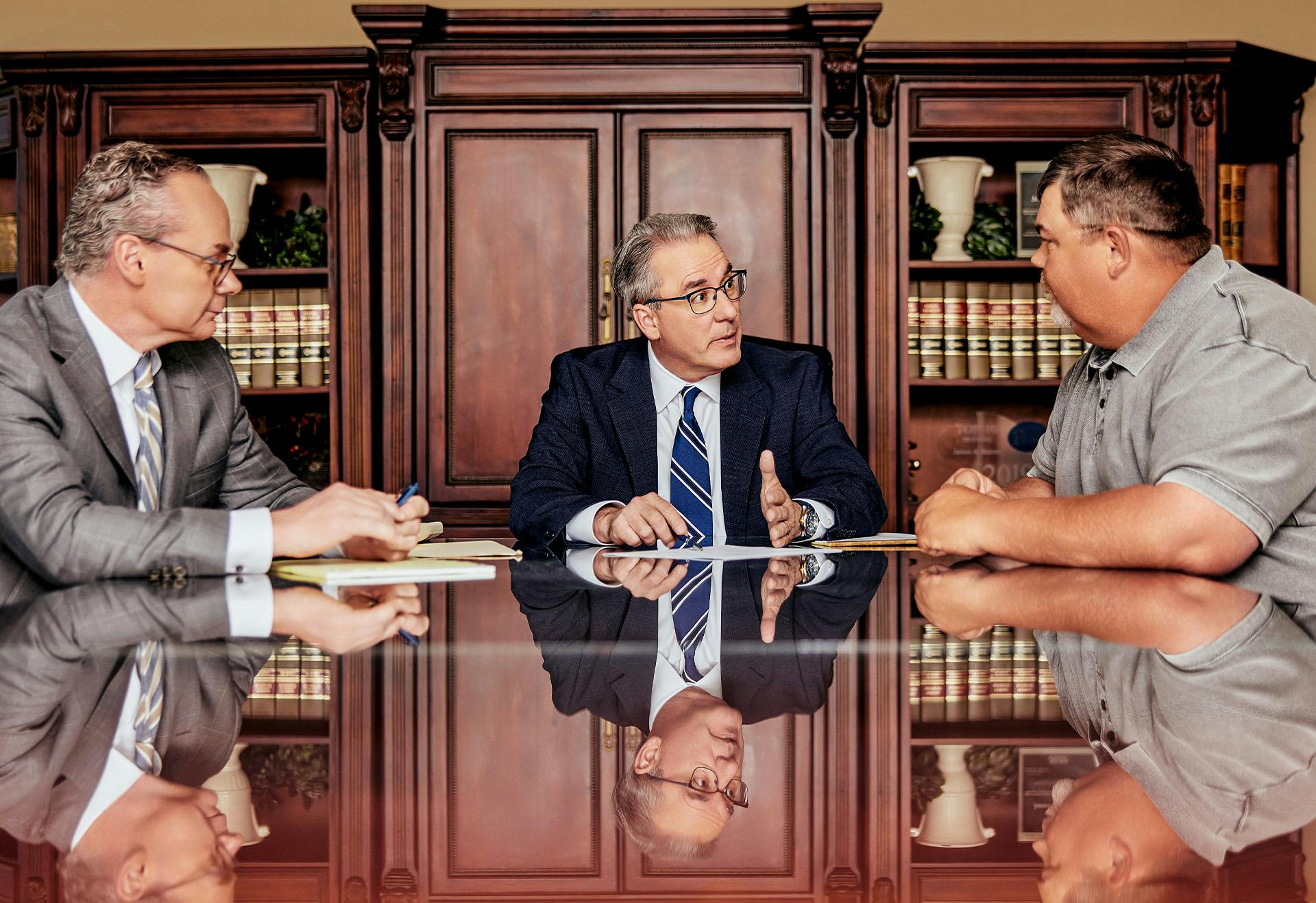 Attorneys Stipe & Belote talking to their client.