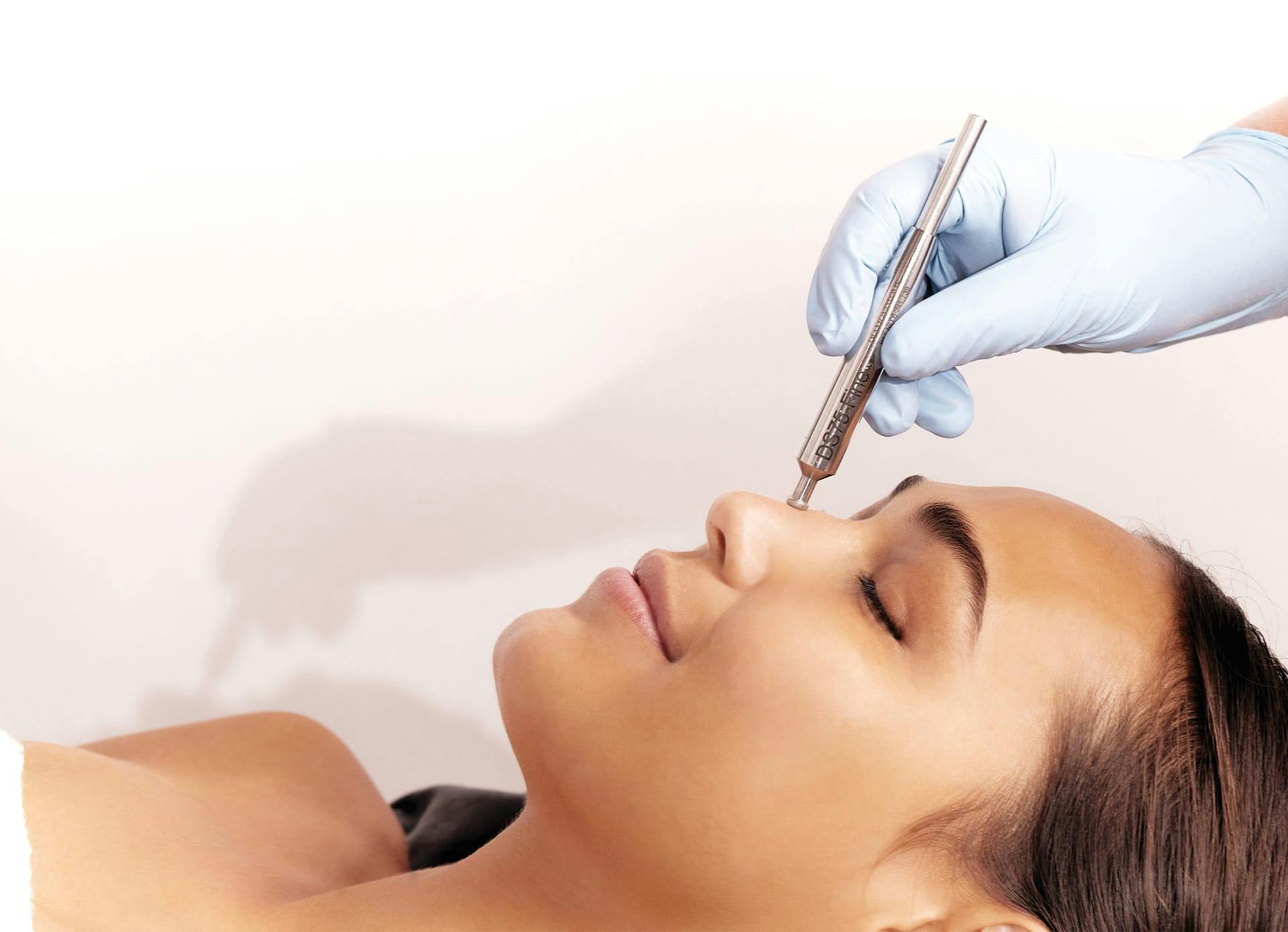 Woman Receiving DiamondTome Treatment on the Face