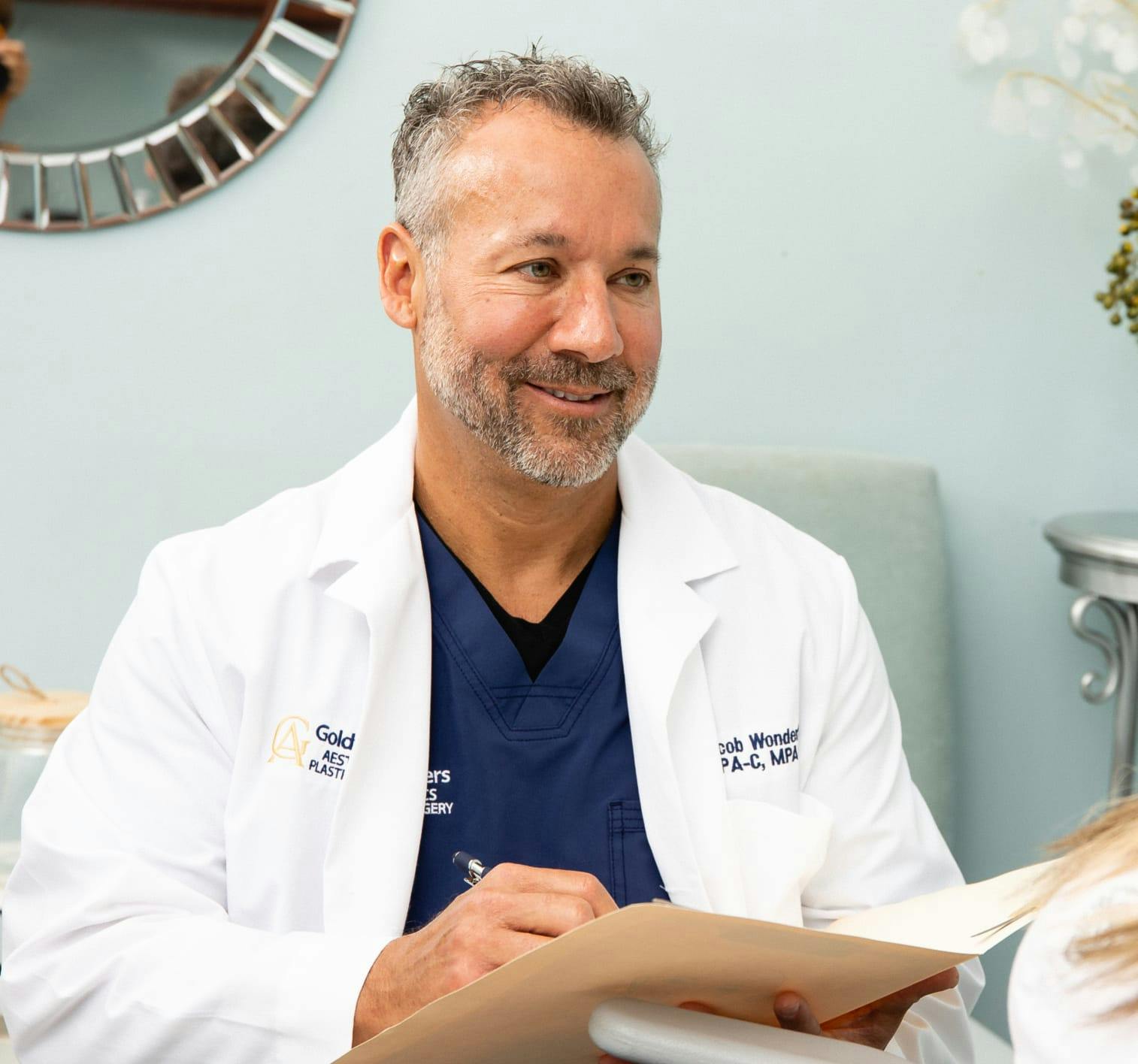 Doctor in a lab coat smiling.