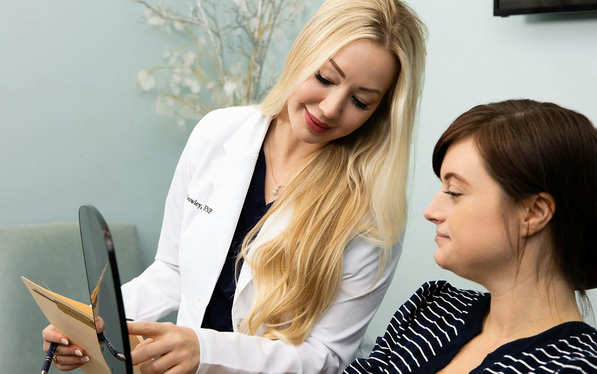 Doctor showing patient chin in mirror