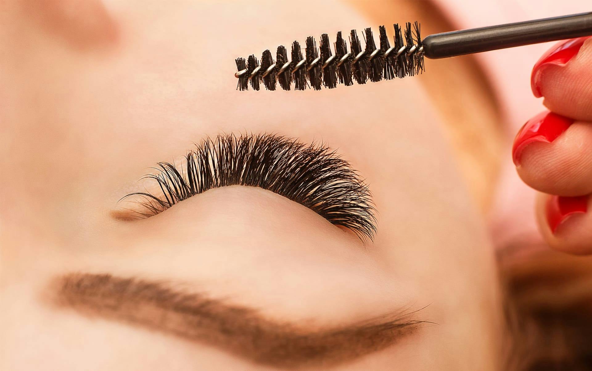 Womans eyelashes being brushed