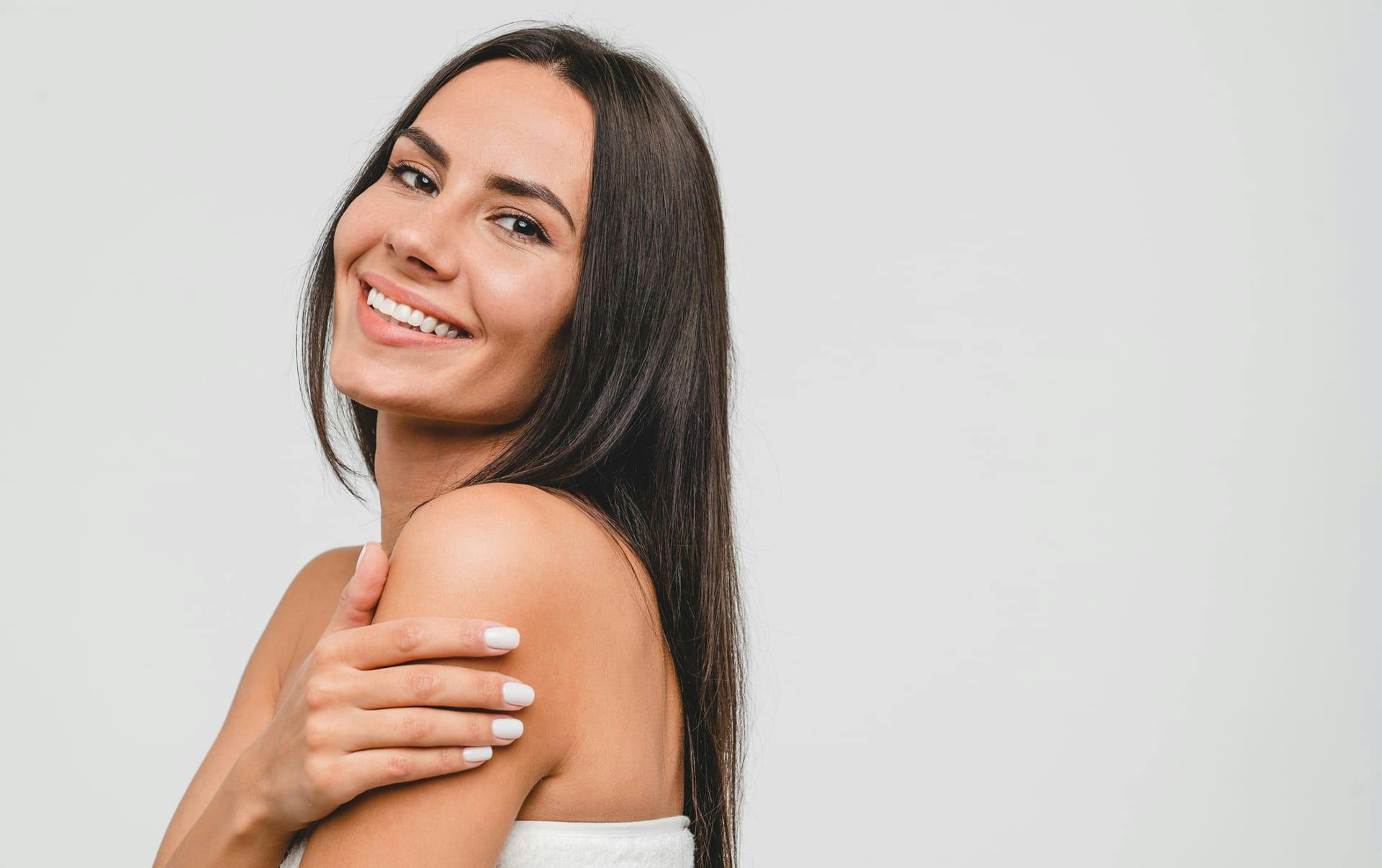 Brunette woman smiling over shoulder