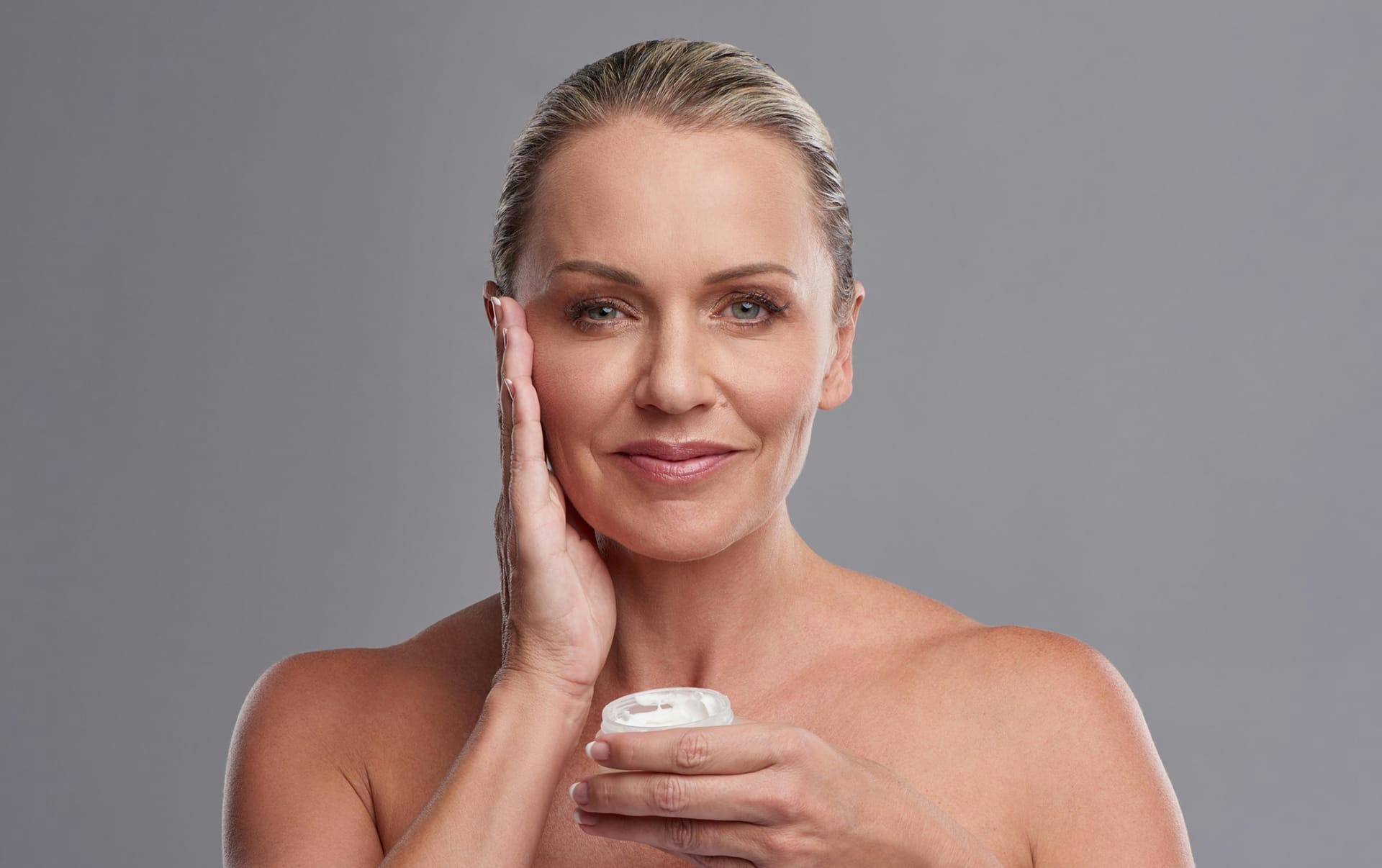 Woman applying face cream