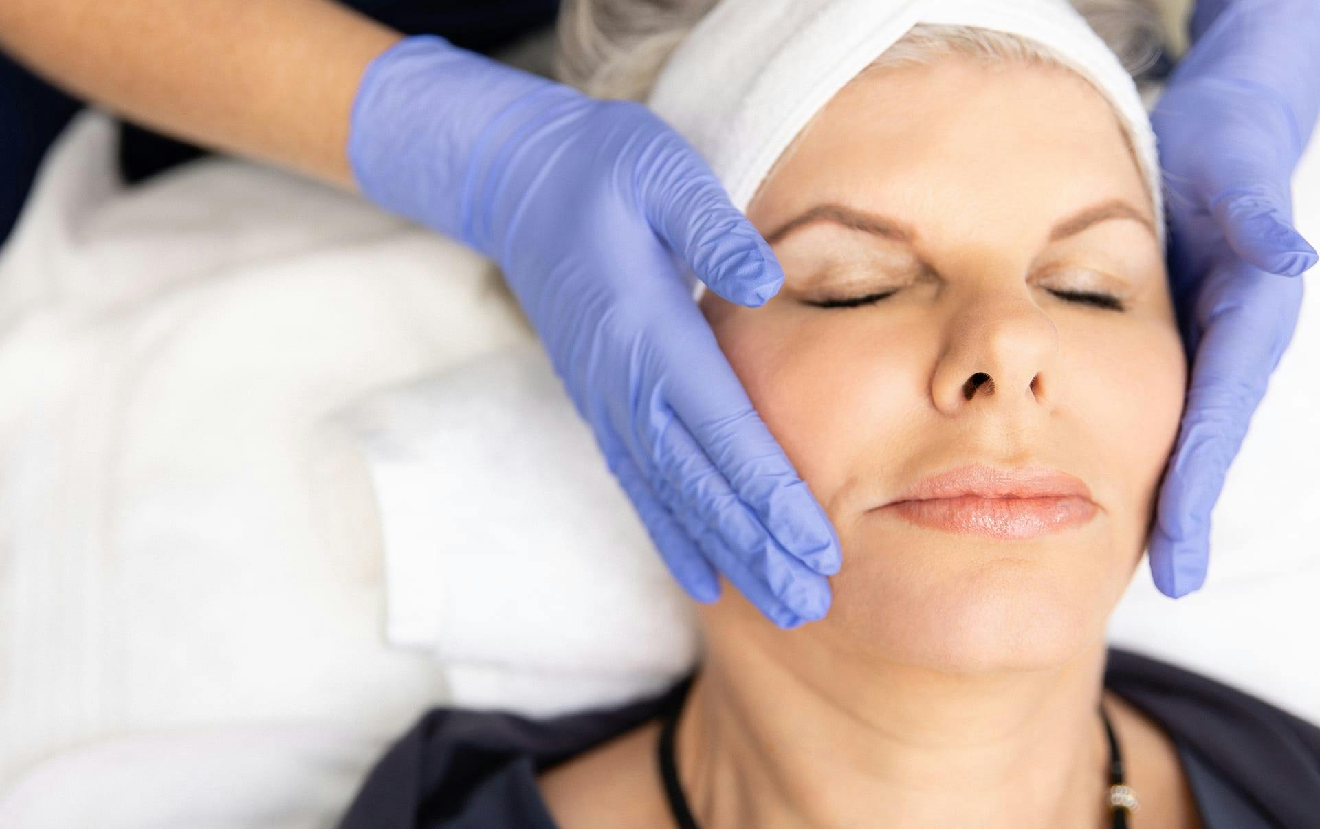 Woman receiving facial spa treatment