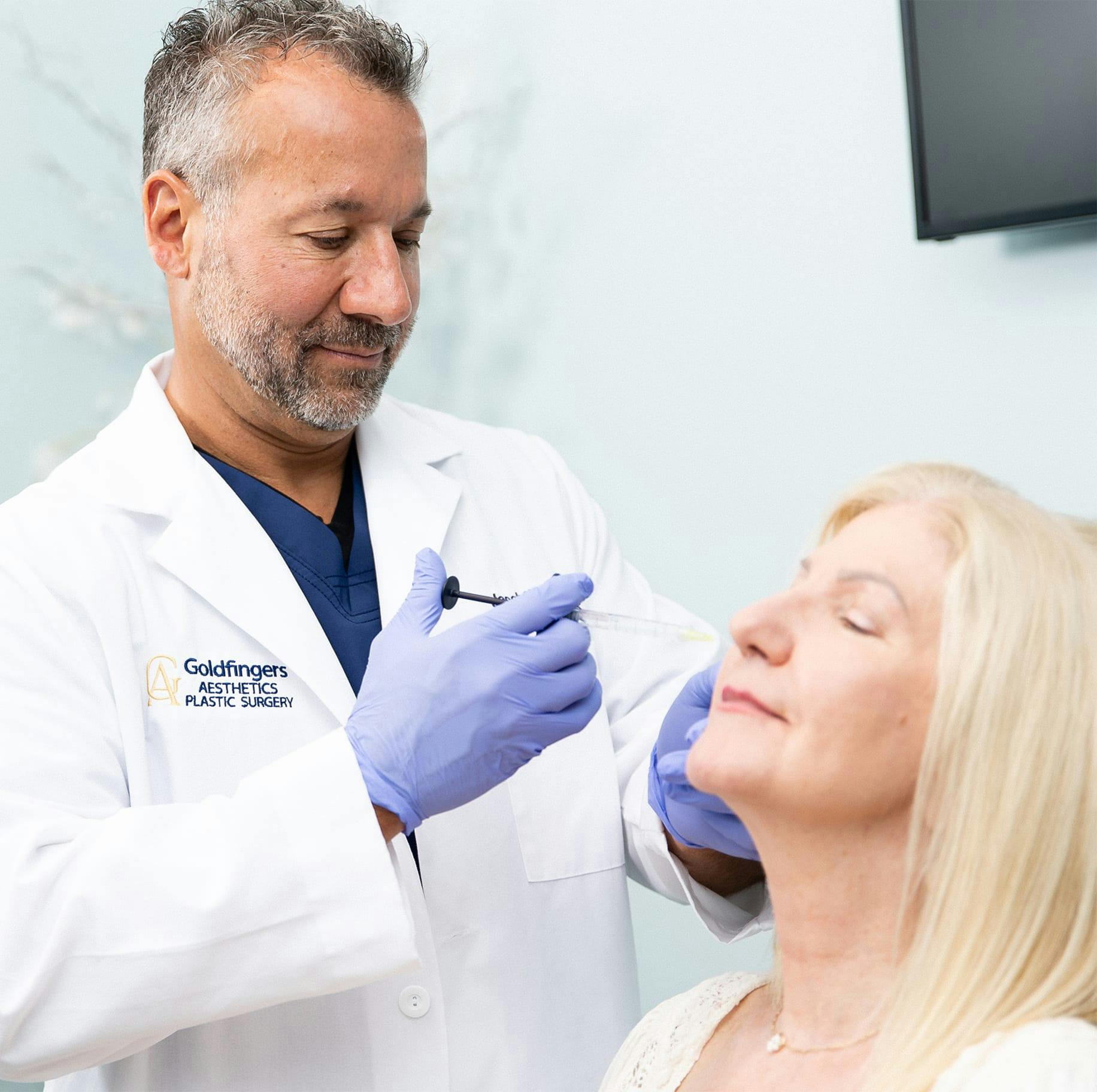 Specialist putting syringe in patient's face